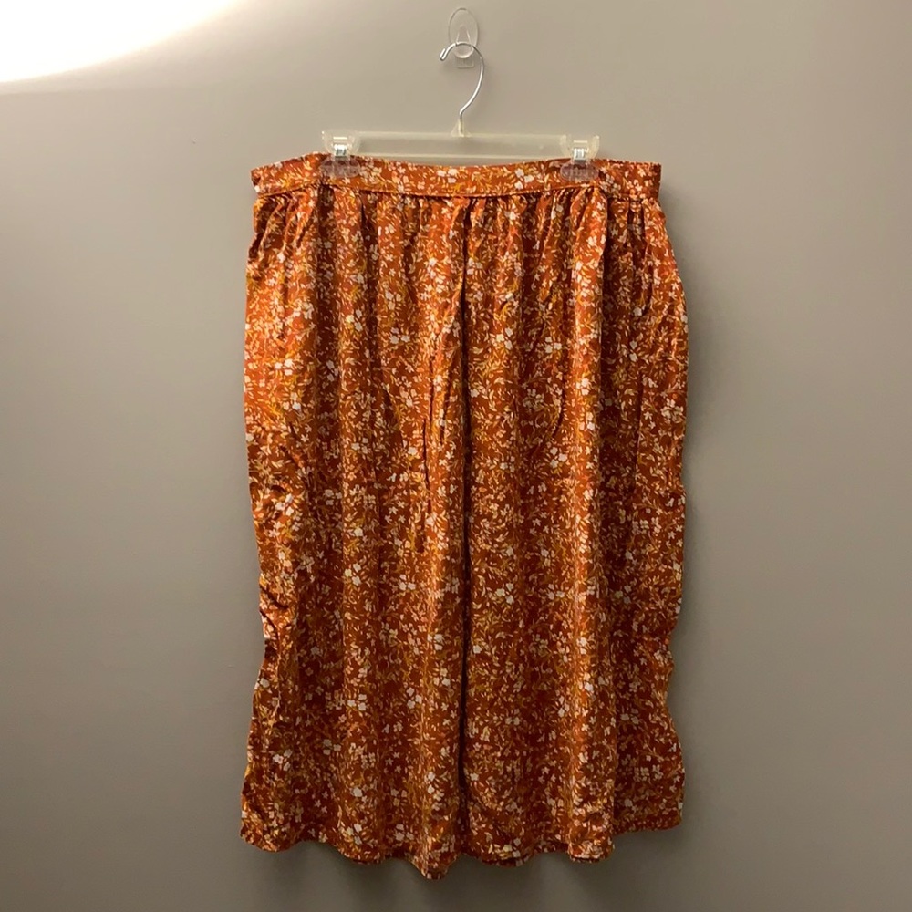 Midi length rust floral skirt.